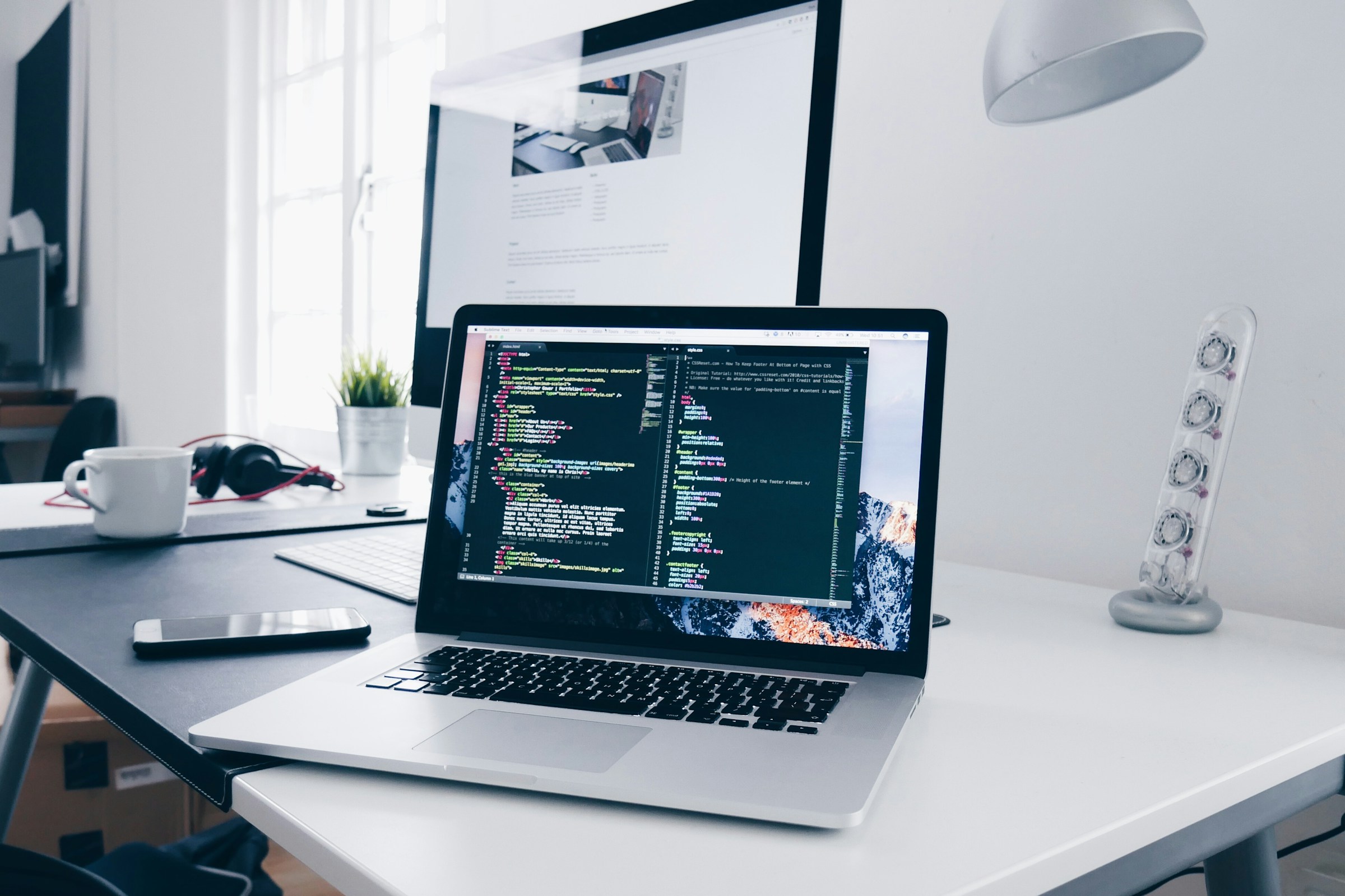 A developer working late at a multi-monitor workstation